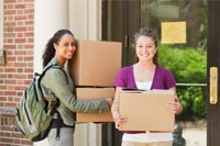 Two students carrying boxes