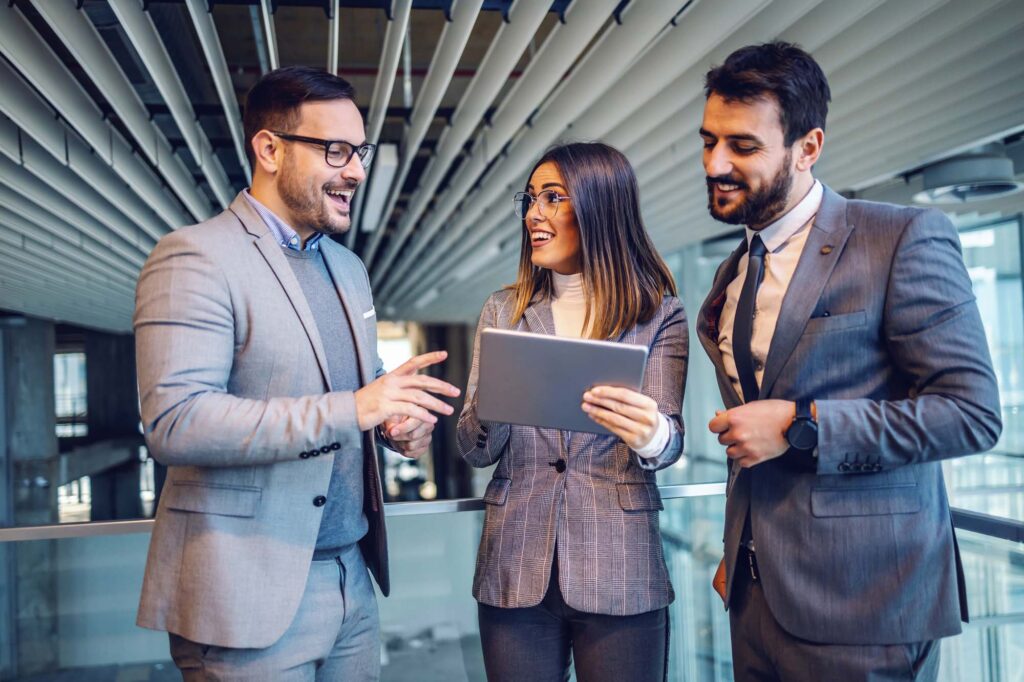 Group of professionals talking to each other in a commercial building. Relating to appraisers and valuers involvement in this approach.