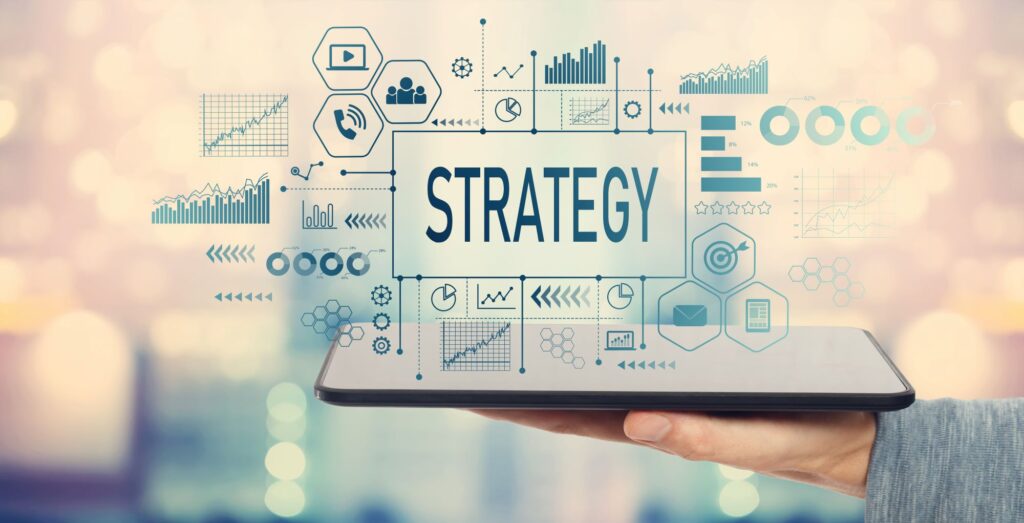 A man holding a tablet with the word strategy and icons depicting strategy on the tablet screen.