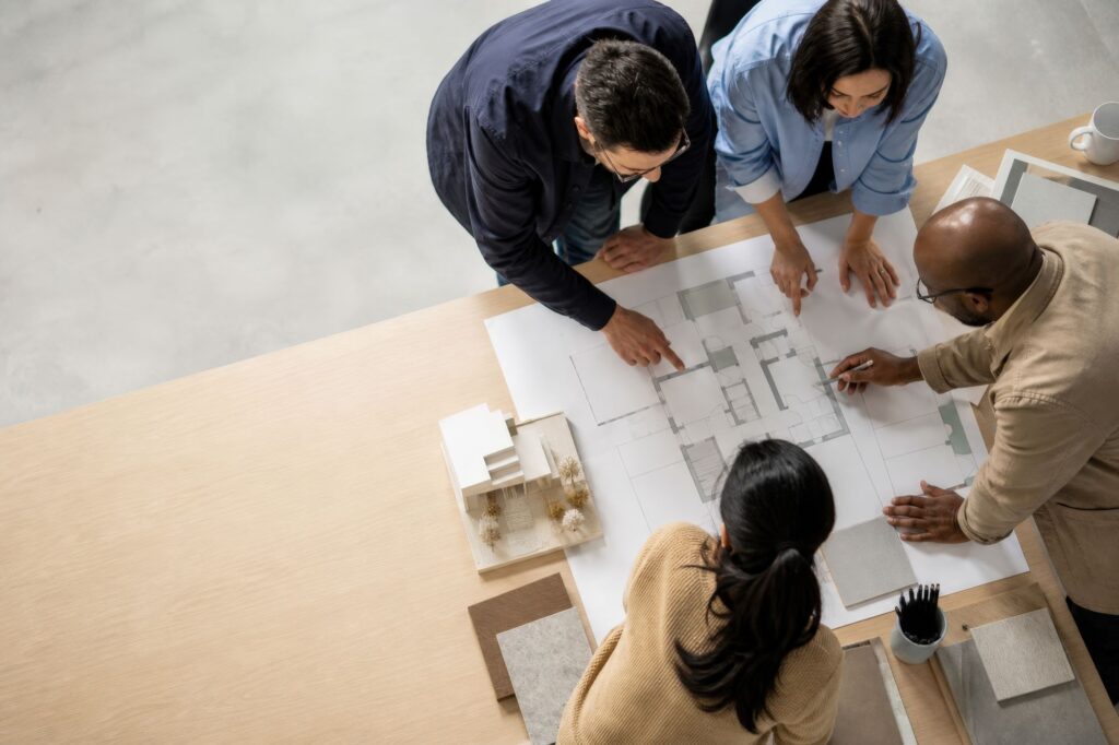 People in a meeting reviewing a floor plan