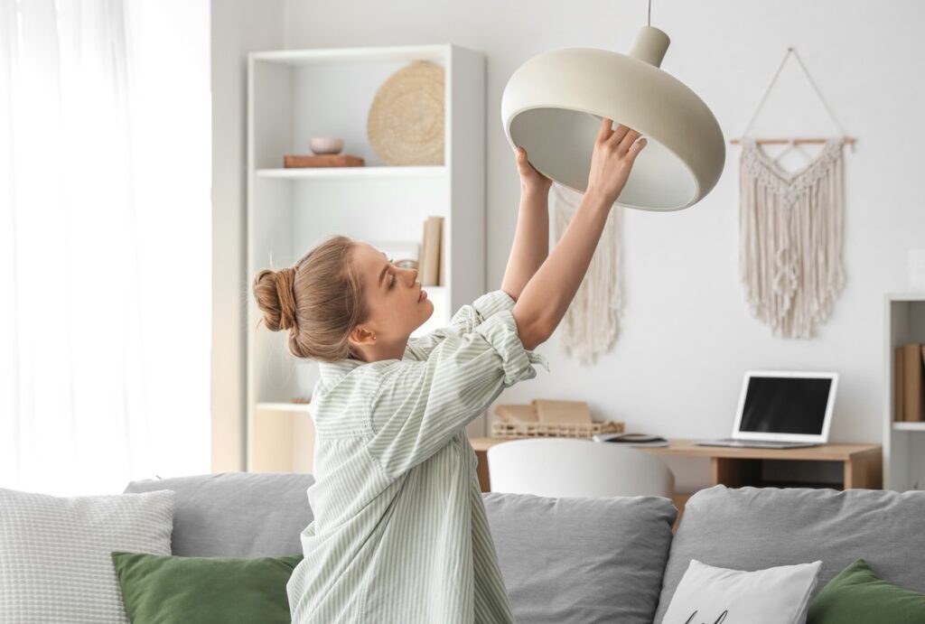 A person changing a lightbulb, energy efficient lightbulbs