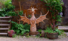 A locally crafted wooden dragon guards the castle's entrance