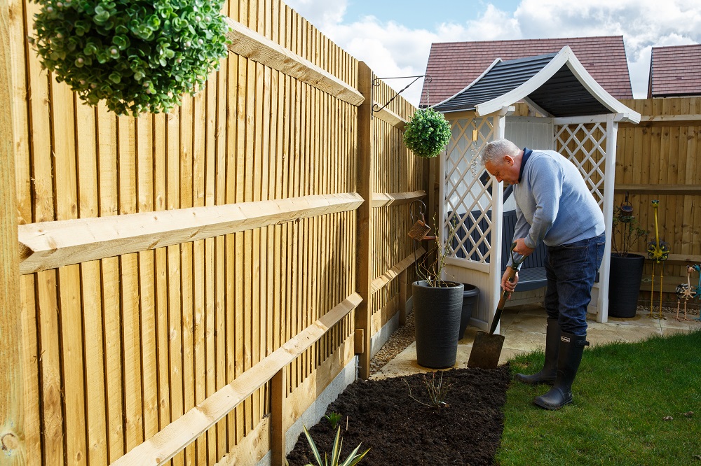 A person digging a border in a garden