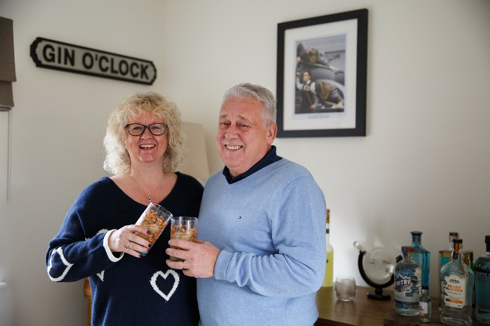 Two people clinking glasses