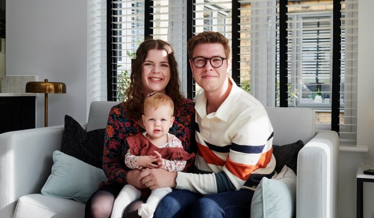 Three people sitting on a sofa