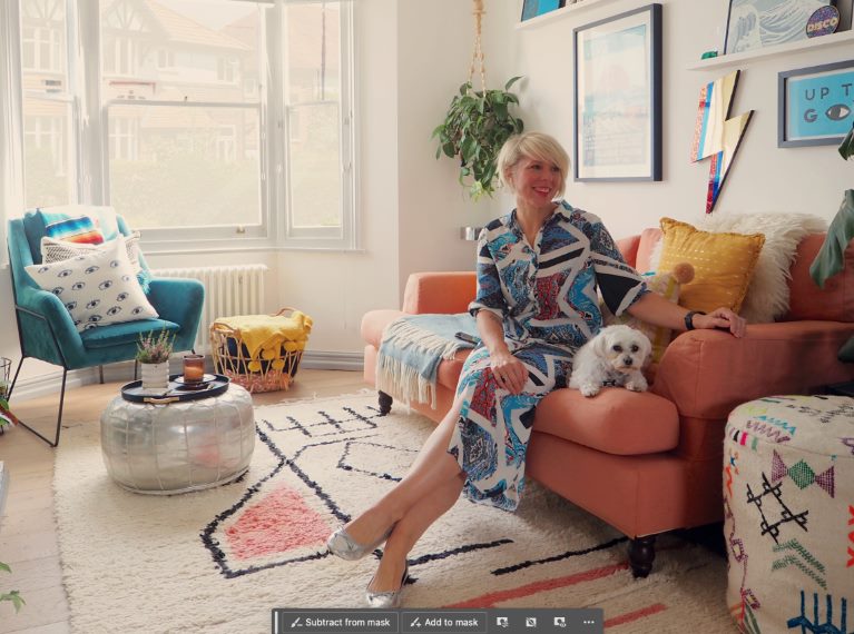 A person and a dog in a living room, sitting on a sofa