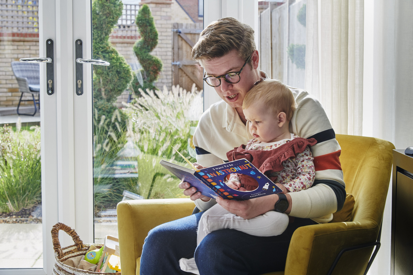 A person reading a book to a baby
