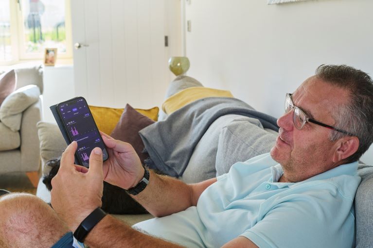 A person on a sofa looking at a phone