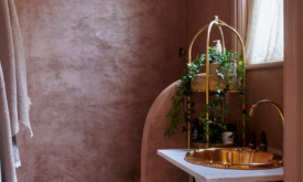 AFTER: Amira decided to create a shower room entirely out of micro-cements in a soft-pink shade, combined with gold accents