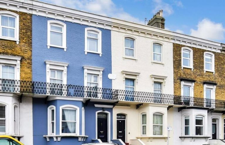 A row of Victorian terraced houses, blue sky