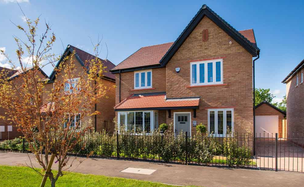 A 4-bed detached home with a garden on a sunny day