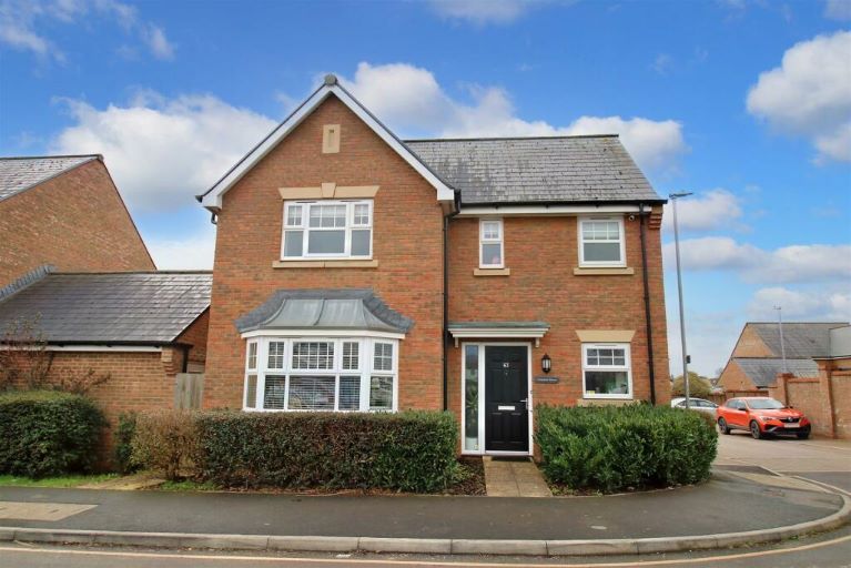 A detached red brick home