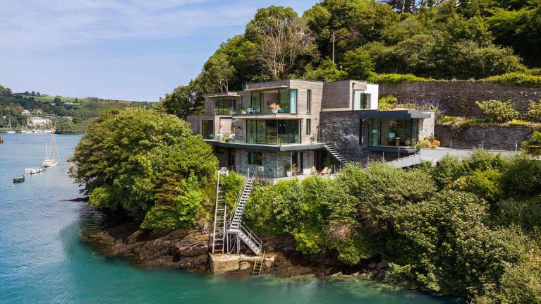 A glass-fronted home overlooking an estuary