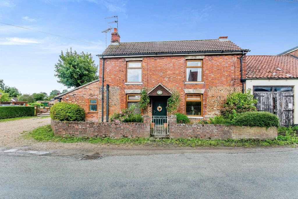 A red brick cottage, blue sky