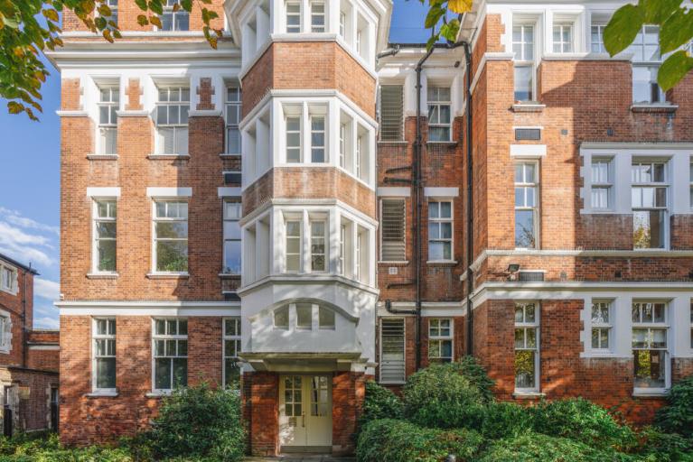 A red brick block of flats in the sunshine