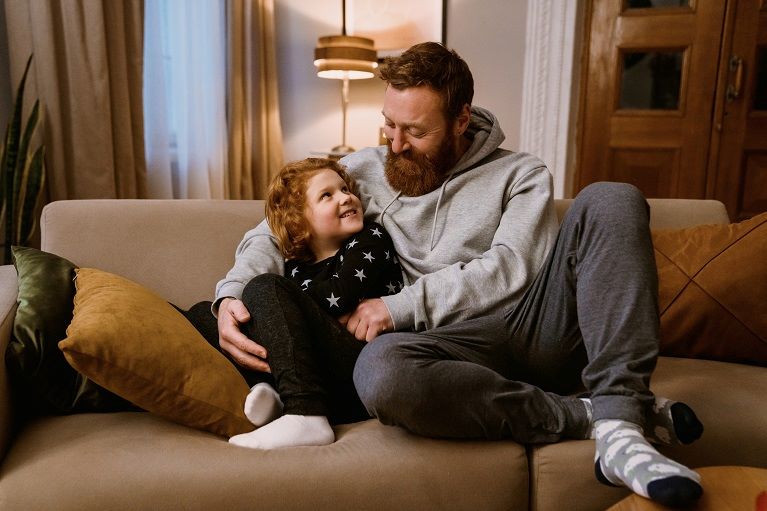 Two people sitting on a sofa in a lounge