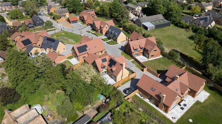 An aerial view of houses with solar panels