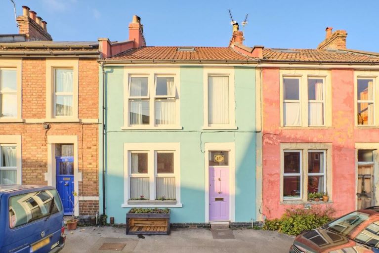 Pastel-coloured terraced houses, blue sky