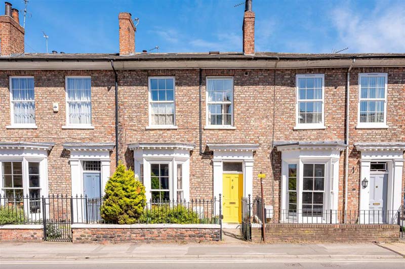 A row of terraced houses with colourful doors