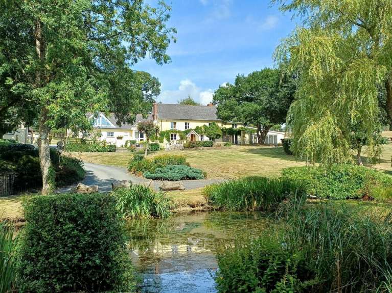 A yellow house, trees, blue sky