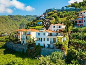 A white property on a hillside in Madeira