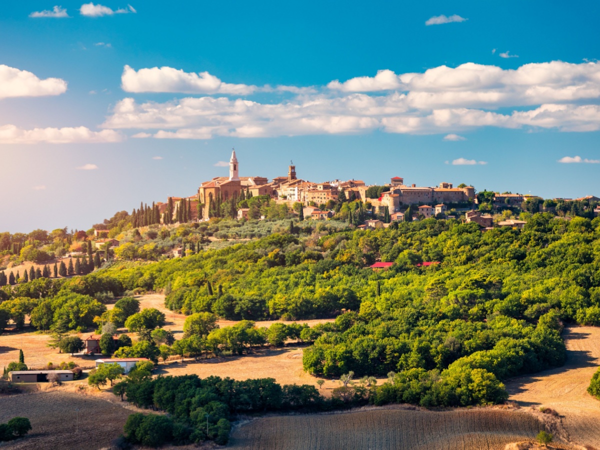 A medieval town in rural Italy surrounded by lush green trees